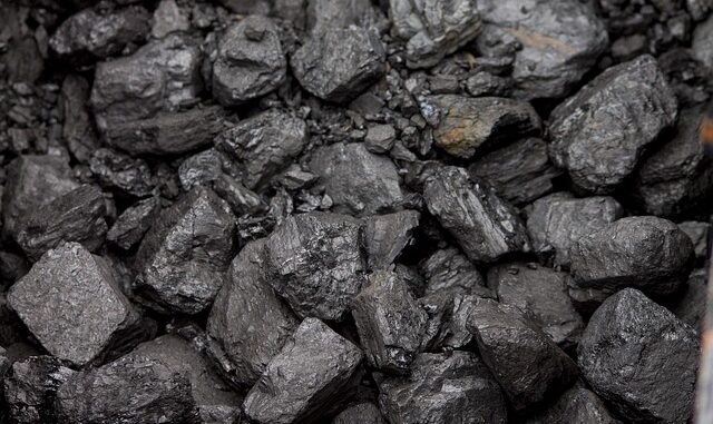 Grafika przedstawia czarne bryły węgla kamiennego .